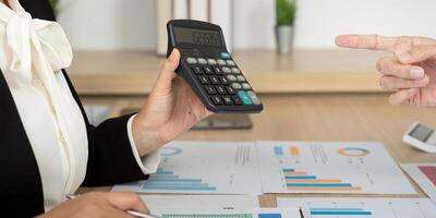 Accounting Consultation with Calculator. Business professional analyzing financial data. photo