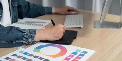 Digital Design. Professional Using Graphic Tablet for Color Palette Creation photo