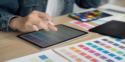 Design Process. Creative designer using tablet for color selection and digital design. photo