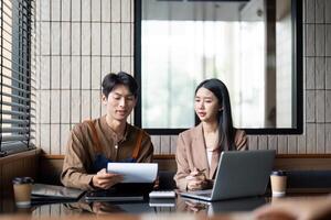 Effective Teamwork. Young professionals collaborating on a project in a modern office environment. photo