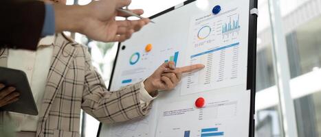 Data Analysis and Presentation. Professional team reviewing business metrics in a modern office. photo