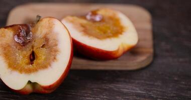 cut apple that has begun to deteriorate and become covered with rot due to long storage or damage photo