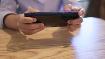 hand playing mobile game, close-up, woman gamer competition play game online with smartphone, streaming game online concept, finger of woman touching scroll page app on mobile phone video