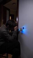 A young boy is using a flashlight to light up a wall video