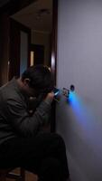 A man is using a flashlight to light up a wall video