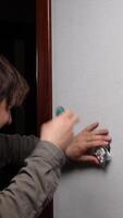 A man is using a screwdriver to remove a piece of paper video