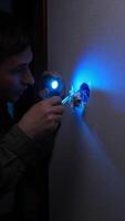 A man is using a blue light to turn on a light video