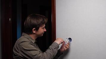 Electrician installing and repairing a light switch while smiling with satisfaction after completing the job, embodying the essence of home renovation and electrical expertise video