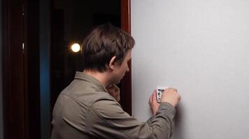 A man is adjusting the temperature of a room video