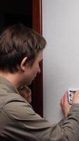 vertical Electrician father is carefully teaching his young daughter how to use a screwdriver on an electrical light switch, promoting learning and family bonding video