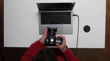 A person using a camera to take a picture of a laptop video