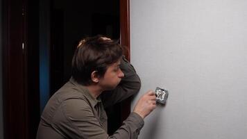A man cannot repair the wiring, outlet, switch at home. An upset man expresses anger and irritation from failure. An angry electrician is angry at the broken wiring, outlet video