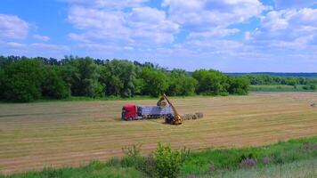 a tractor is working in a field with a tractor and a trailer video