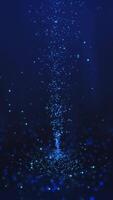 Blue tornado at the center of particles twirling on the ground and flying in the air with light rays at the top center, vertical composition. Standard speed. Loop animation footage for graphic design. video