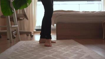 An enchanting display of elegant feet stepping barefoot on a soft rug, showcasing the beauty of comfort and fluid movement in a warm, inviting indoor setting, creating a serene atmosphere video