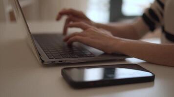 The image shows a closeup of hands typing on a laptop, with a smartphone on the desk, highlighting the modern workspace and the importance of digital connectivity in todays fastpaced world video