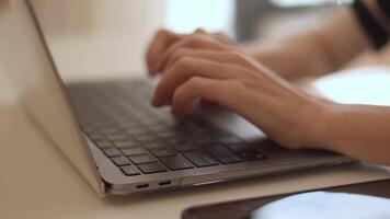 A dedicated and focused individual sits and types intently on a sleek laptop, seamlessly blending productivity and creativity in a serene, modern workspace that inspires and encourages new ideas video