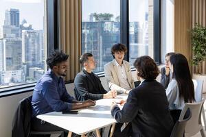 Team of diversity business people are discussing over new strategic strategy project on investment real estate while working in modern office building for new project and planning concept photo
