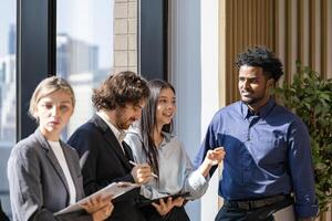 Team of diversity business people are discussing over new strategic strategy project on investment real estate while brainstorming around the office building for new project and planning photo