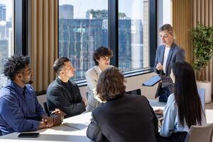 Caucasian woman sale manager is showing annual report chart to colleagues in executive meeting for next year plan with market share increase for global business and investment photo
