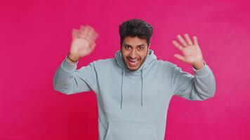 Happy man smiling friendly waving hands gesturing hello greeting or goodbye, meeting invitation video