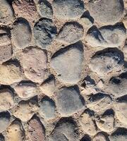 extured surface of historic pavement - close-up of weathered gray stones with natural black variations. Universal background for interior concepts and exterior design presentations photo