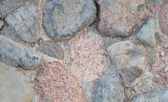 Panoramic aged stone pavement close-up showing organic gray and black textures. Perfect as a wide format background for design projects or wall decor photo