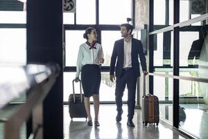 Flight attendant is walking together with pilot captain at the airport while on the way to boarding aircraft photo