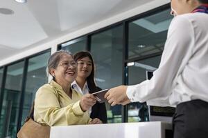 Airline ground staff using metal scanner for security check every passenger in the airport departure terminal for safety protocol before boarding into plane photo