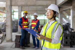 Team of asian engineer in full safety gear is inspecting inside the building structure for investigation over specification on construction site industry and quality control photo
