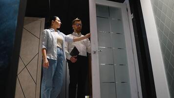 Consultant showing door features to couple in showroom video