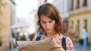 Woman lost while traveling in Europe city, exploring sightseeing, navigating holds tourist paper map video