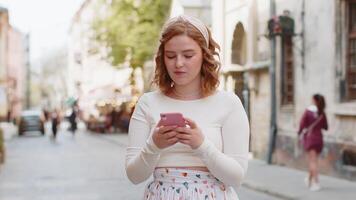 Young woman using smartphone typing text messages looking for a way on map in mobile navigator app video