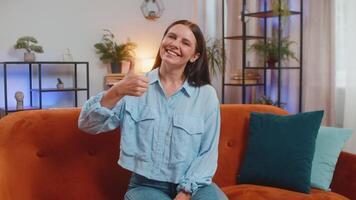 Portrait of excited smiling woman showing thumbs up, like sign positive feedback good news approve video