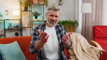 Dissatisfied mature man arguing talking on call complains about problems looking in camera video