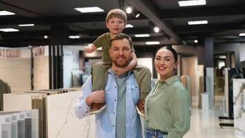 Happy family choosing tiles in a showroom with consultant video