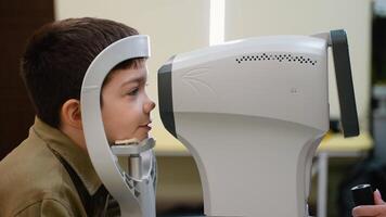 Young boy undergoing comprehensive eye examination using modern equipment video