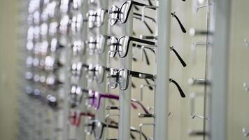 Eyeglasses display stand in optical store showing variety of frames video