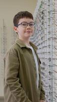 Young boy trying eyeglasses in optical store video