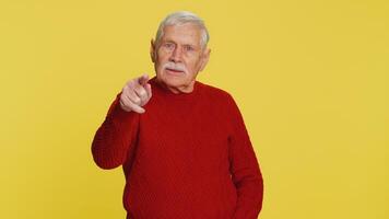 Happy Senior smiling man pointing finger to camera making winner choice, showing direction, select video