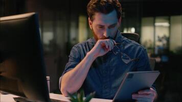 Caucasian middle-aged businessman stock market trader business man broker computer trading analyst CEO manager in night evening office professional employer in glasses tired overtime working overwork video