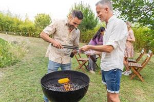 Multiracial people around the barbecue smiling happy and laughing together. Joy concept. photo
