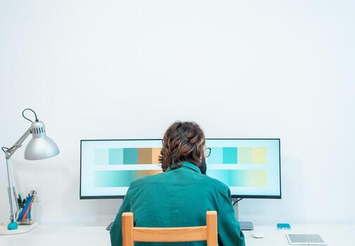 Unrecognizable graphic designer working with computer at modern office with copy space. photo