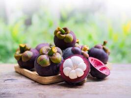 A ripe mangosteen, ready to be eaten, is on the table. photo