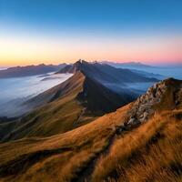 Majestic Mountain Ridge at Sunrise with Fog and Golden Grass photo