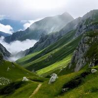 Misty Mountain Valley Landscape with Green Hills and a Path photo