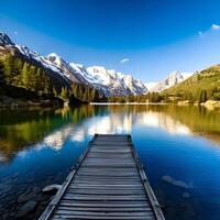 Serene Alpine Lake with Wooden Dock and Mountain Reflection photo