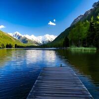 Serene Mountain Lake with Wooden Dock and Stunning View photo