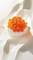 Captivating orange Osetra caviar balances on porcelain with verbena-infused foam ripples photo