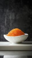 Delicate orange Osetra caviar on porcelain with verbena foam accents highlights minimalism in gourmet presentation photo